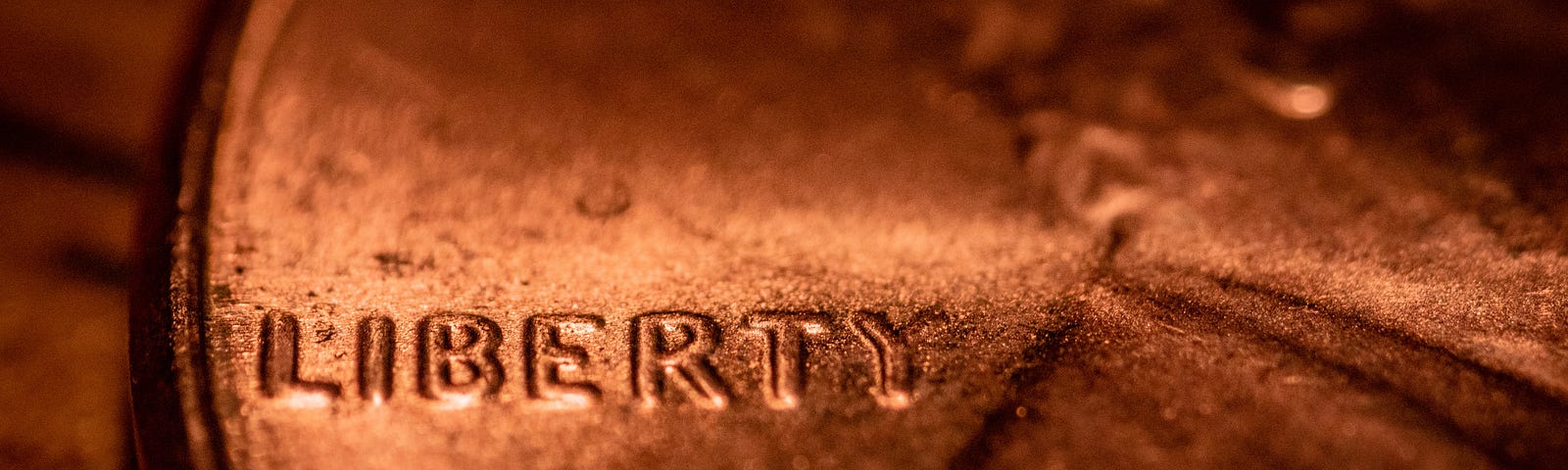 Close up of an American penny with the word liberty