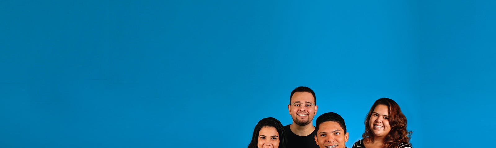 Four friends in front of a blue background