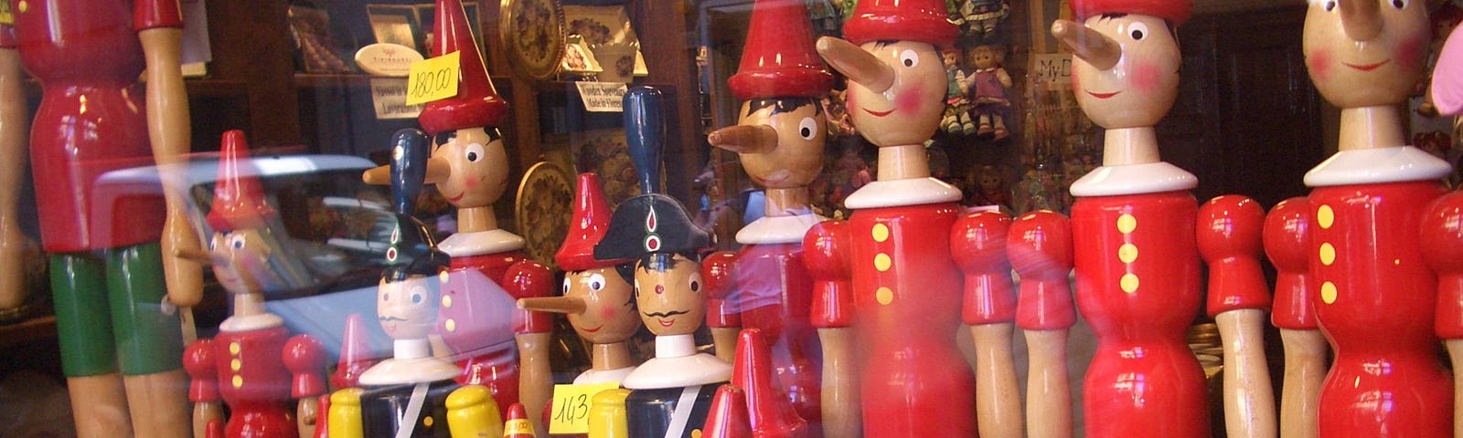 A shop in Florence, Italy, with multiple Pinochio puppets of various sizes, and some other dolls.