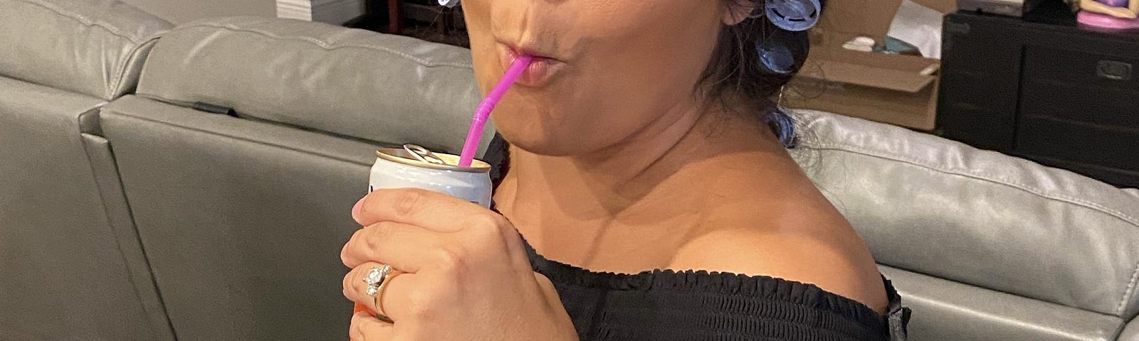 Photo of the author with her hair in curlers sipping a beverage about to talk tea.