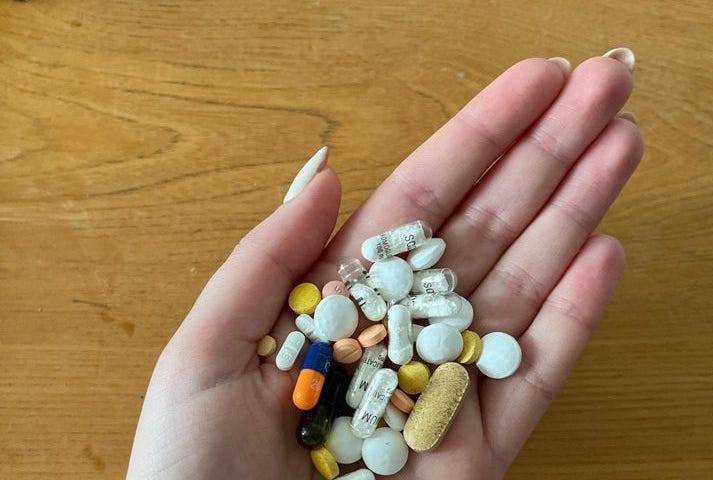 Instagram post. The picture shows Rachael’s palm turned up, holding 40 tablets of different sizes and colours. Caption reads: Happy Disability Pride Month. Credit: Rachael Mole.