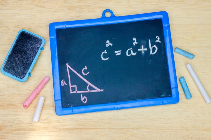 Pythagorean theorem on blackboard, written in chalk. iPhone next to blackboard