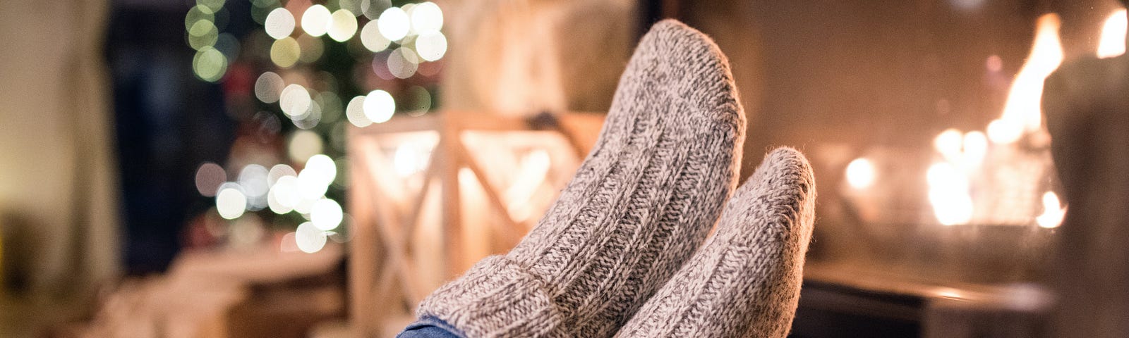 Feet in comfortable socks resting on stool