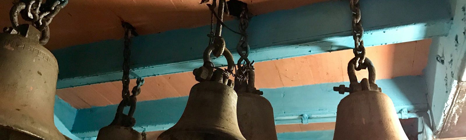 Bells in an ancient Lord Shiva temple hanging from the rafters.