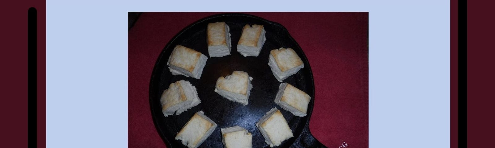 Homemade biscuits on a cast-iron skillet.