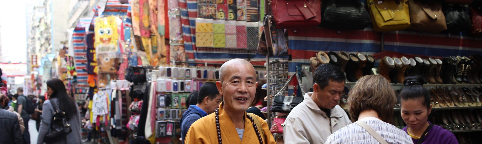 A smiling monk trying to scam tourists in a big city