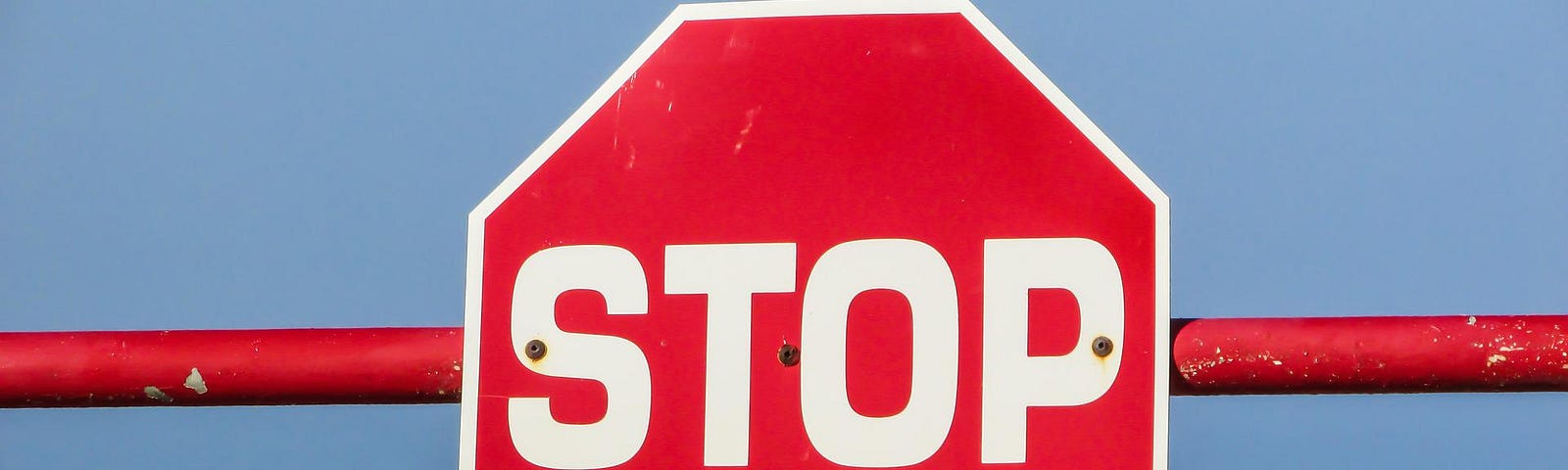 A stop sign bolted to a horizontal crossbar
