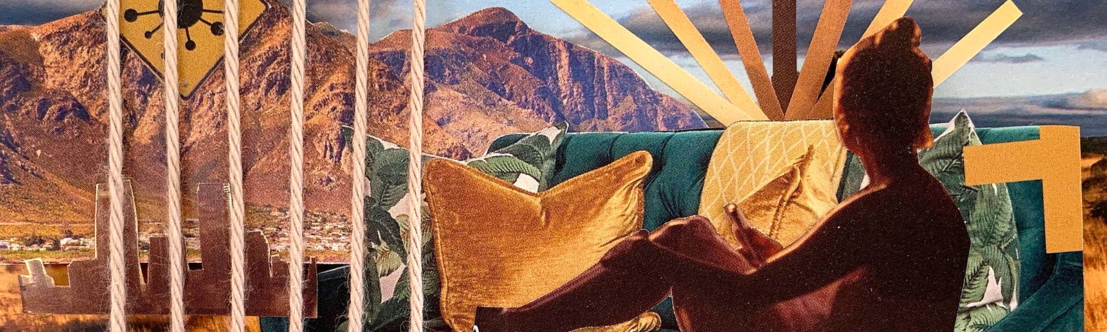 woman sitting on a couch, holding a phone, looking out towards a mountain range