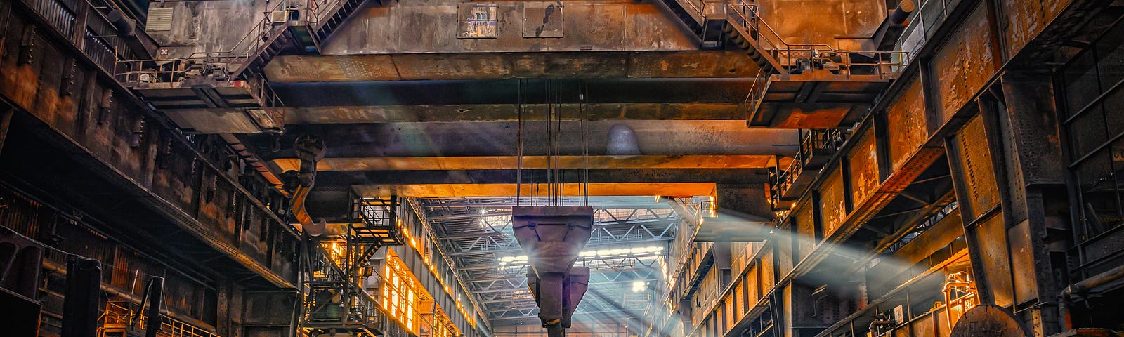 The inside of a steel mill looking all dramatic. The Only Singleton by Jim Latham | Photo by Peter Herrmann on Unsplash