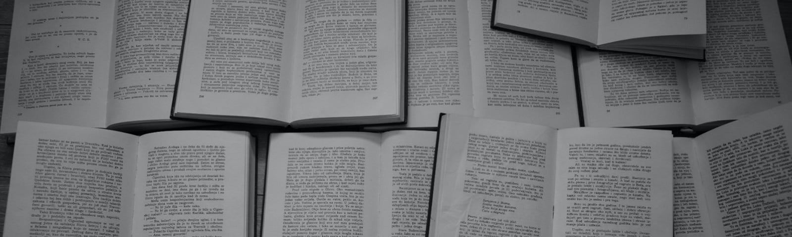 A large image of open textbooks in black and white.