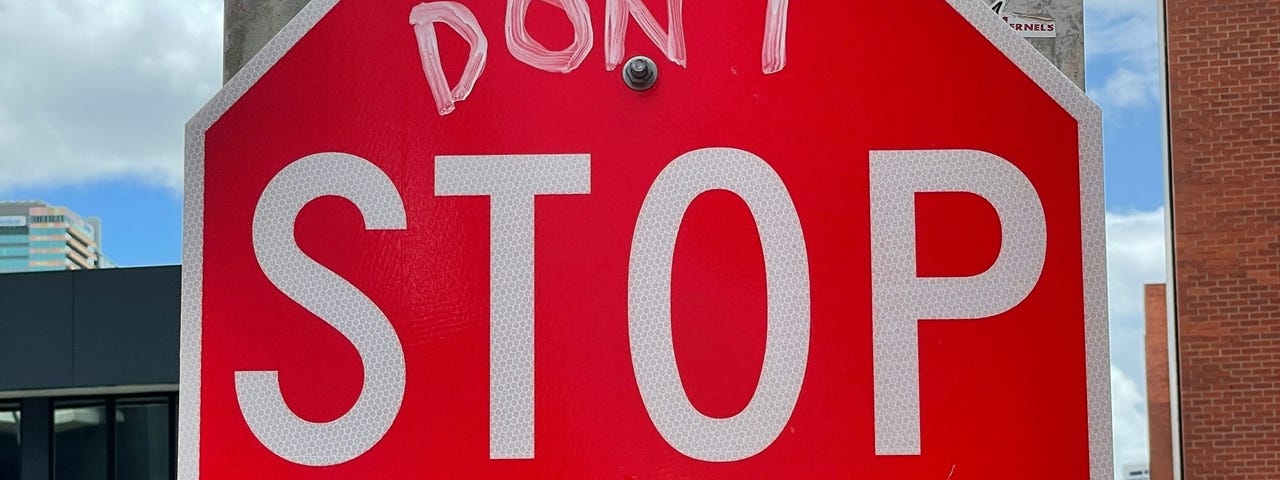 A stop sign modified to say “don’t stop believin”
