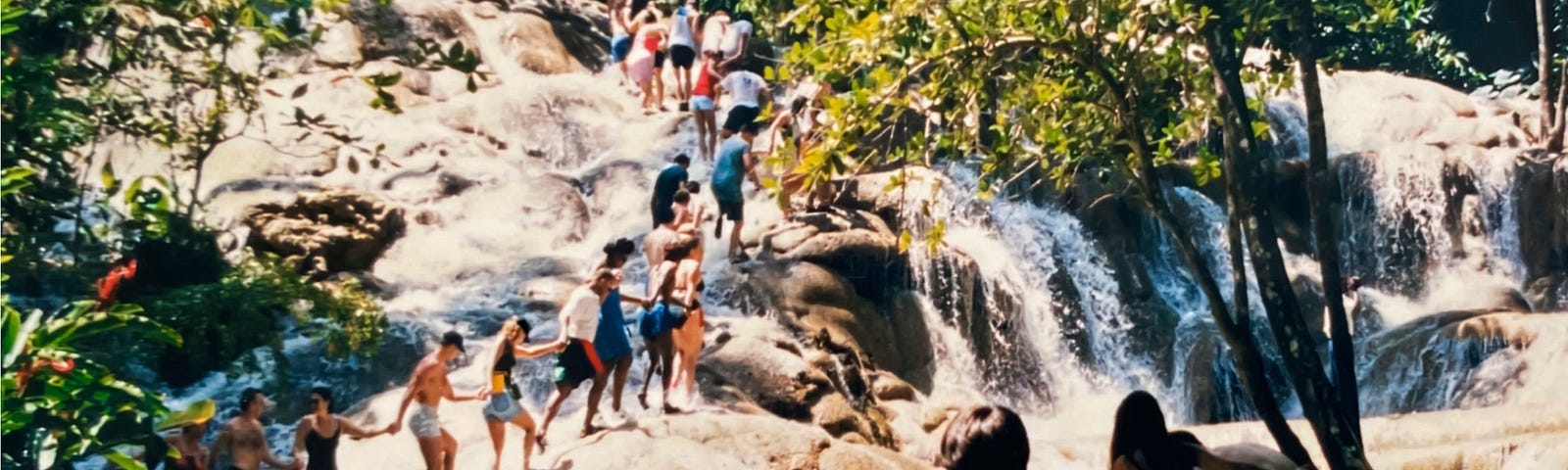 A human chain forms to climb world-famous Dunn’s River Falls in Jamaica | nature photography | © pockett dessert.