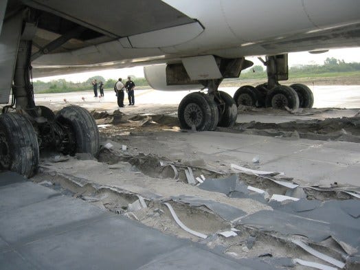 An aircraft with its wheels stuck in EMAS concrete.