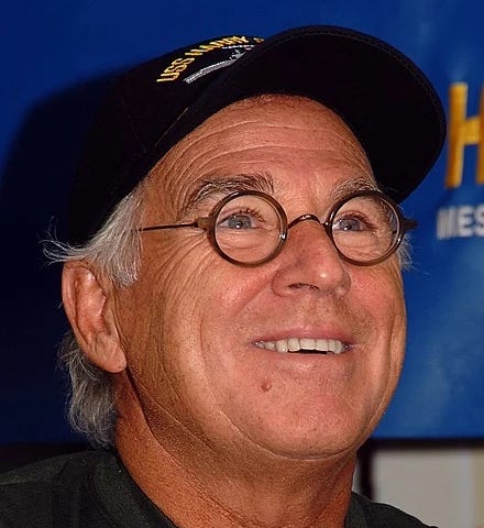 A photograph of a smiling Jimmy Buffett. The American song-writer, musician, and businessman Jimmy Buffett. The billionaire was best known for his tropical rock music, which often portrayed a lifestyle described as “island escapism.” Buffett, the roguish bard of island escapism, recently died of Merkel cell carcinoma, a rare skin cancer.