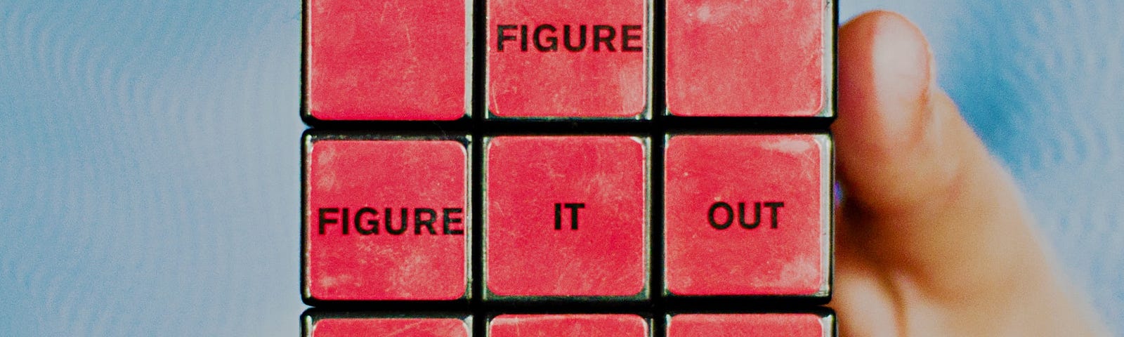Picture of a Rubik’s cube with the words “Figure it out” on it.