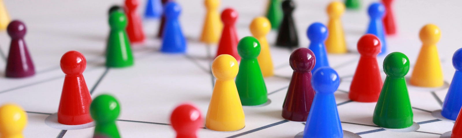 Colourful, plastic, game playing pieces arranged in a network.