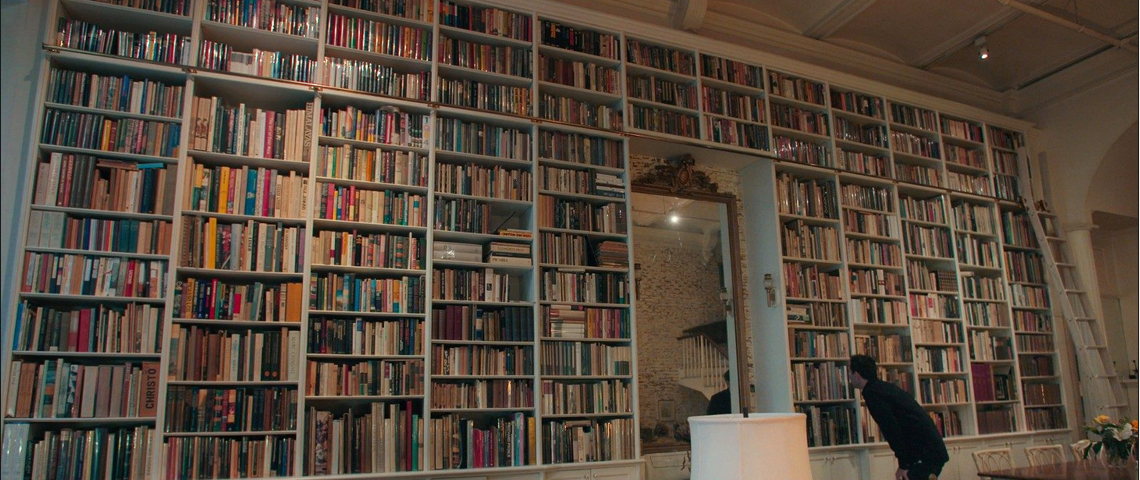 Image of a large wall of books from the film The Bookseller