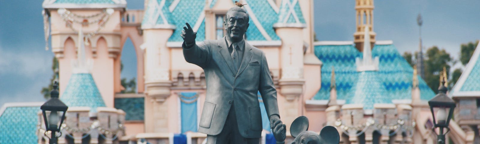 Walt Disney and Mickey Mouse statue in front of the castle at Disneyland