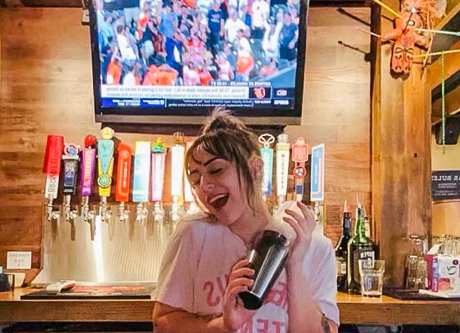 A photo of a female bartender at a local sports bar in Memphis