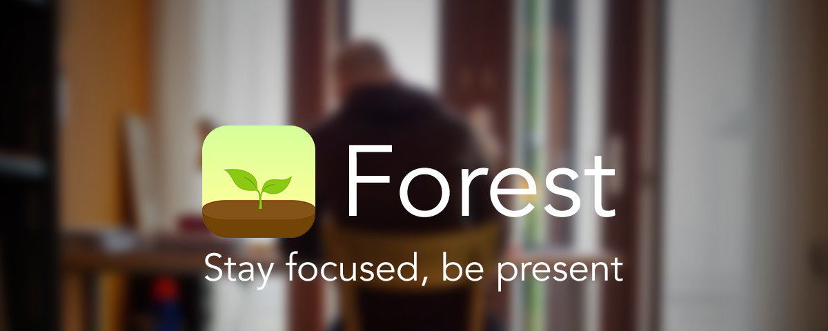 Forest logo with text “Stay focused, be present” overlaid on top of a blurred photo of a person at a desk