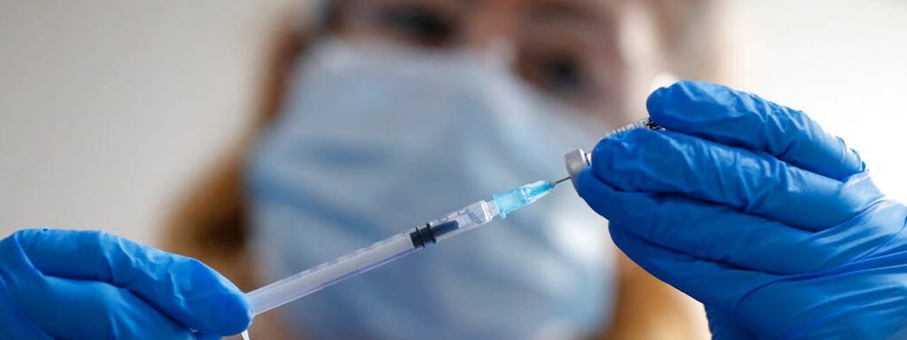 A nurse prepares the Pfizer-BioNTech COVID-19 vaccine in London in December 2020.