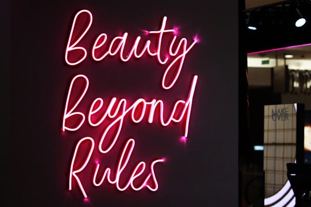 Sign says “Beauty Beyond Rules”