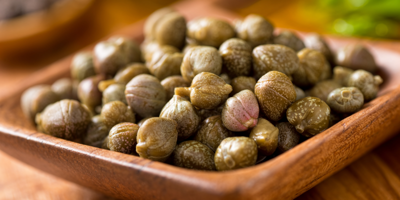 Photo of a wooden dish of Capers — What Are Capers?