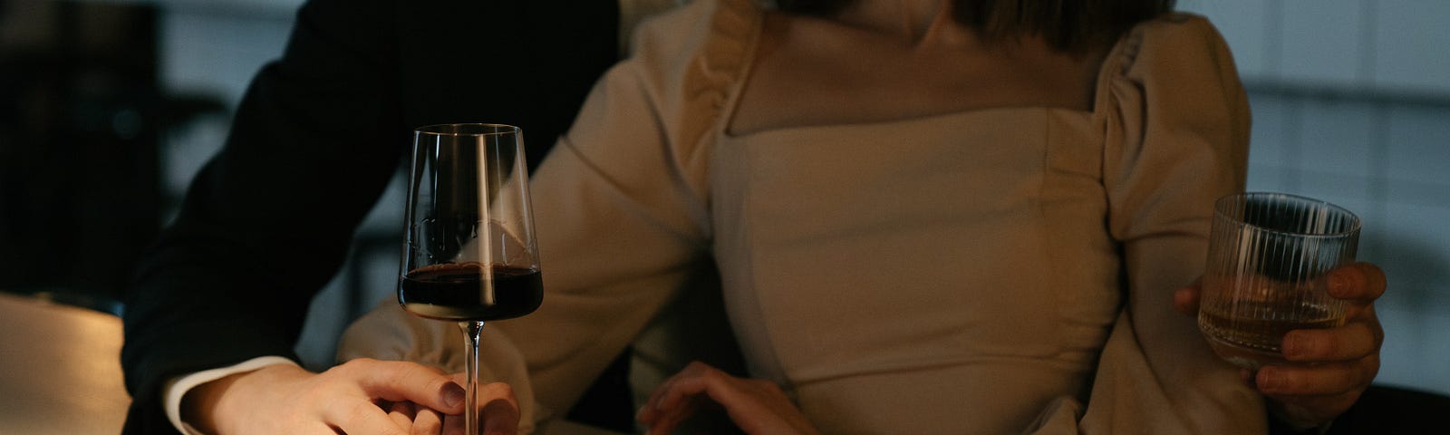 Couple snuggling while drinking wine at a restaurant