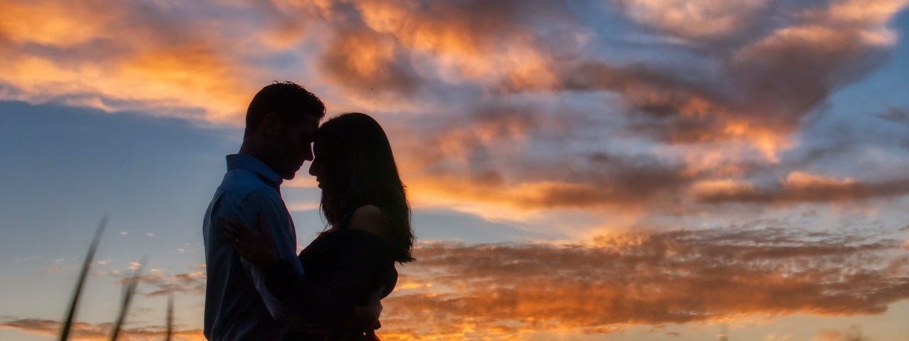 A man and woman standing closely together.