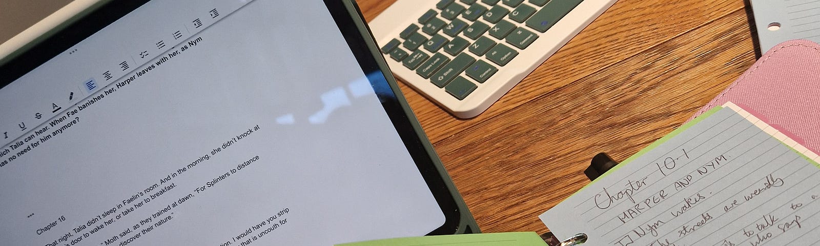 An Ipad and Filofax on a desk with writing notes