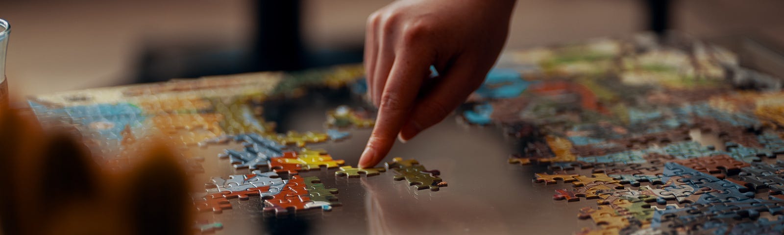 A person laying pieces of a puzzle.