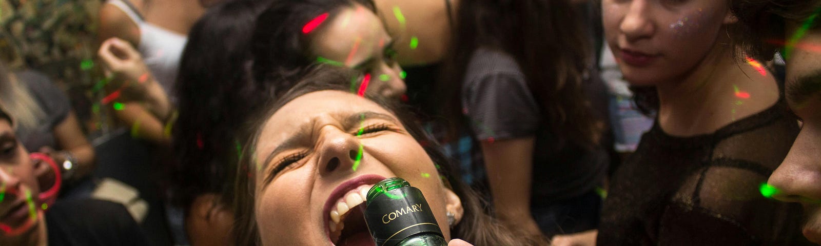 Young woman drinking alcohol at party