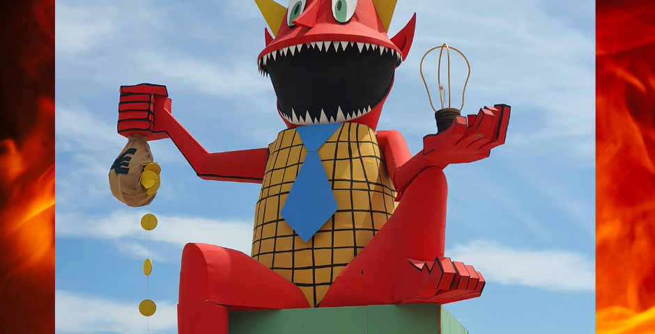 Image of a giant devil dummy on a beach