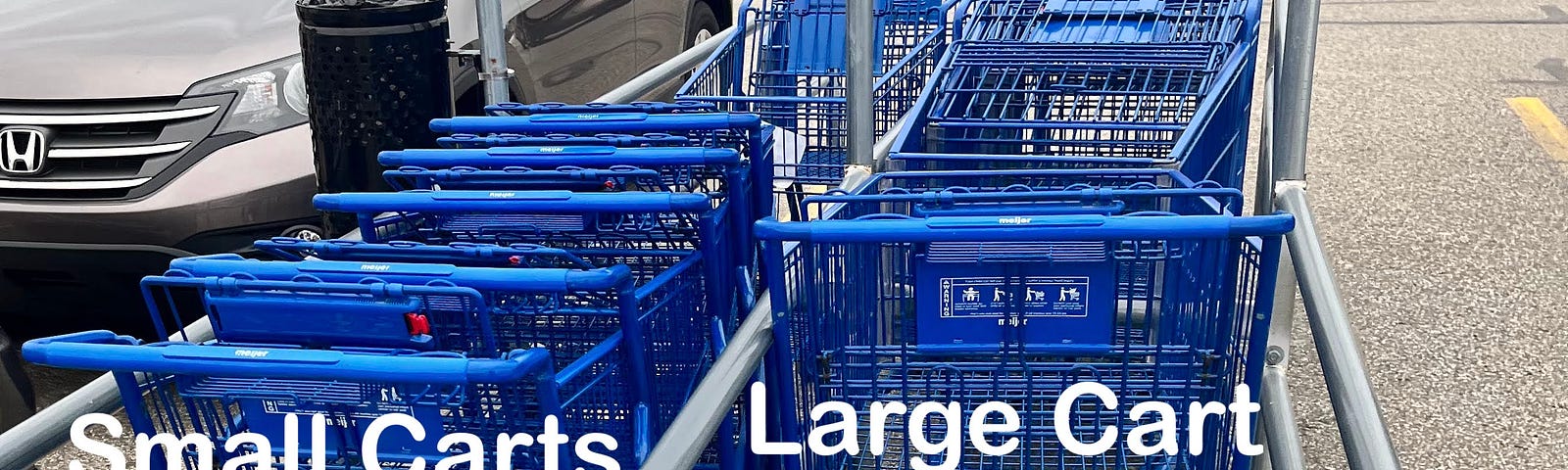 An outdoor photo showing large carts in the small cart lane, and small carts in the large cart lane.