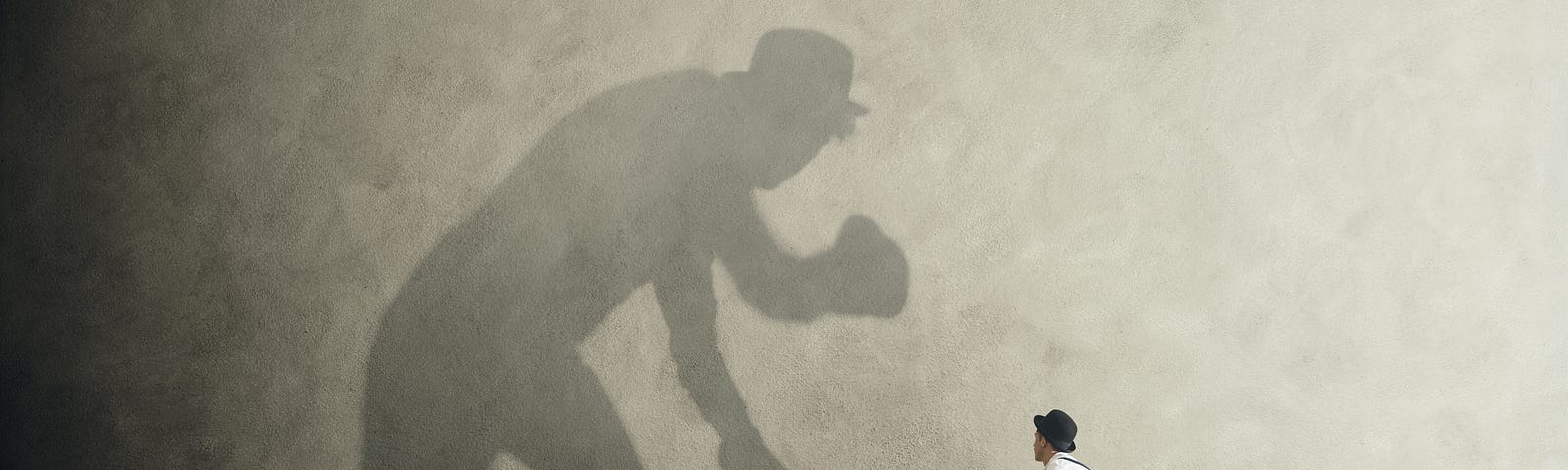 A boxer facing off with his own shadow.
