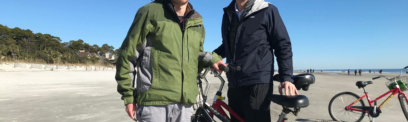 Two men on bikes on the beach