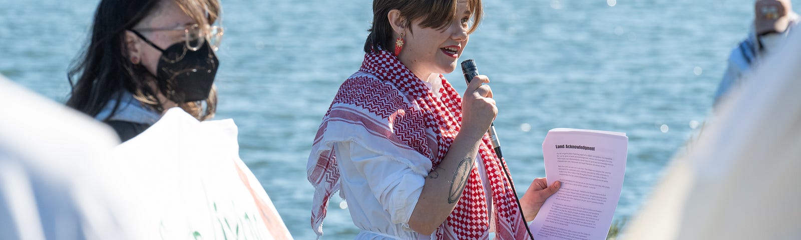 Image of the writer (Miranda Rector) speaking at a public event.