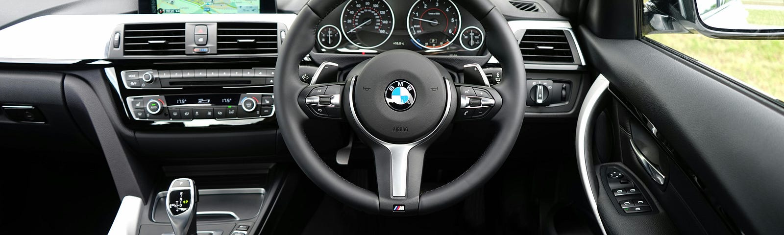 A close up of a steering wheel in a BMW.