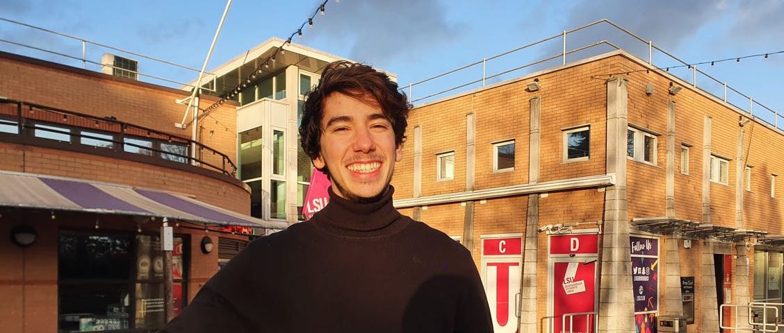 Smiling person on a sunny day with a turtle neck top