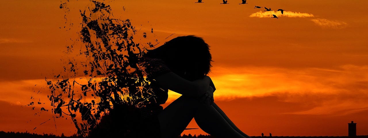 A silhouette of a woman with the sun setting behind her. The womans silhouette is breaking away and dissolving.