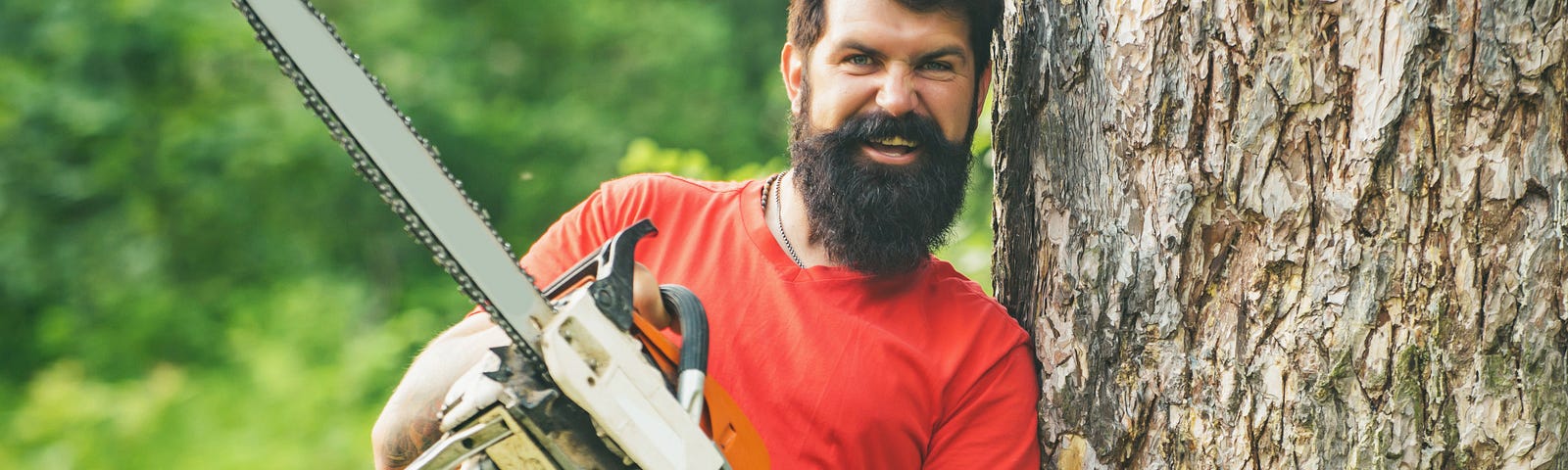 bearded man with chainsaw