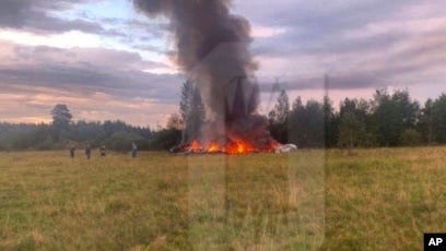 Picure of smoldering ruins of a plan crash in open field