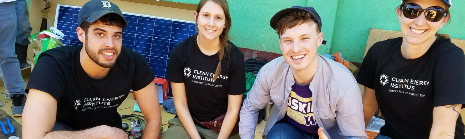 GRID students posing next residential-scale solar energy systems in Guatemala in 2019