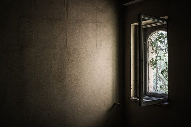 An open window in a dark room.