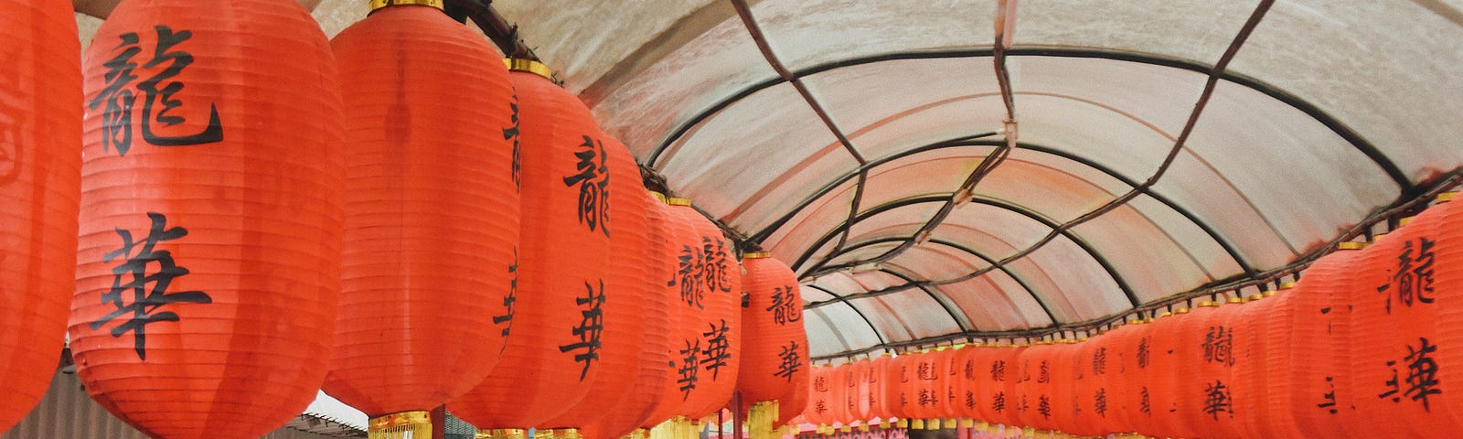 Traditional Chinese lanterns hung along a pathway — symbolism of tradition as the backbone to culture or a chokehold on progress