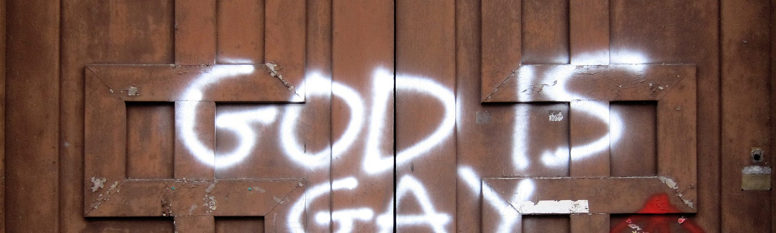 On the door of the Casa del Balilla this graffiti says “GOD IS GAY”. The casa del Balilla is located in Legnano, Lombardy, Italy. Picture taken on the 27th of january in 2022