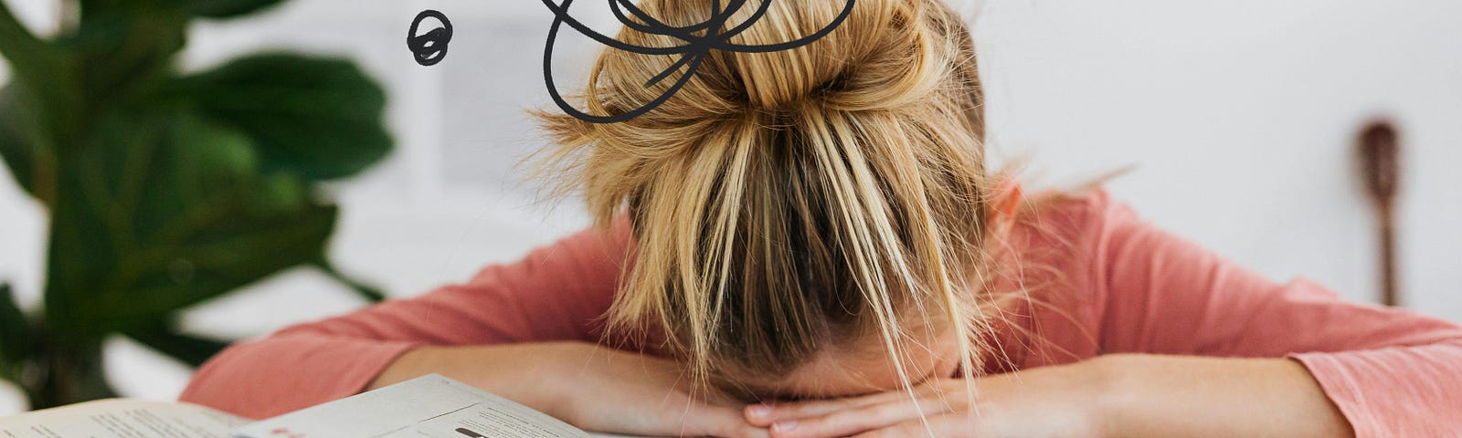 Student has her head down on her open text book