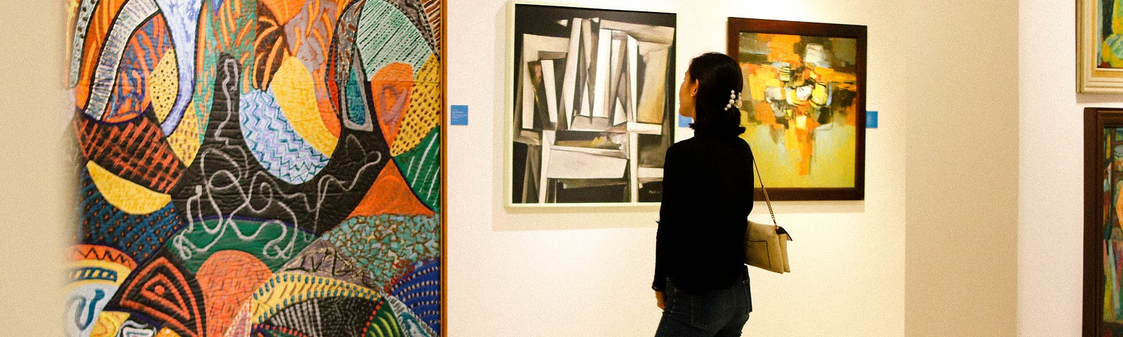 Photo of a girl staring at a colorful in a gallery