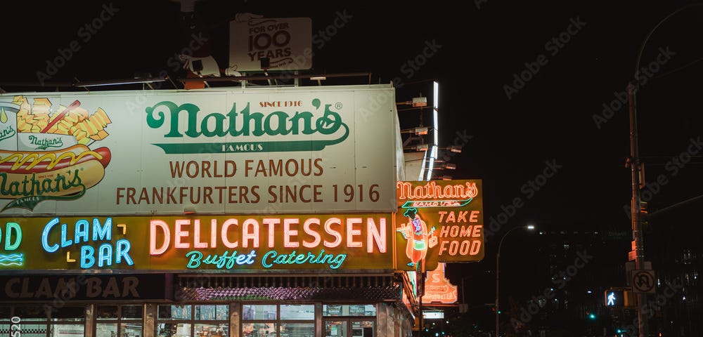 Nathan’s Famous neon sign at night in Coney Island