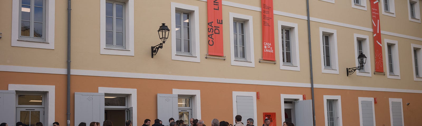 A crowd gathers outside Casa di e lingue, a mother-tongue institute in Bastia, Corsica
